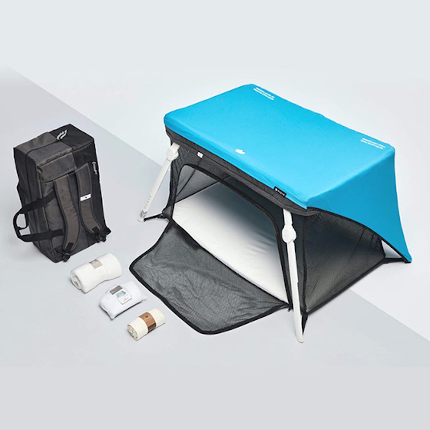 Product image of blue top bassinet with black backpack and folded accessories