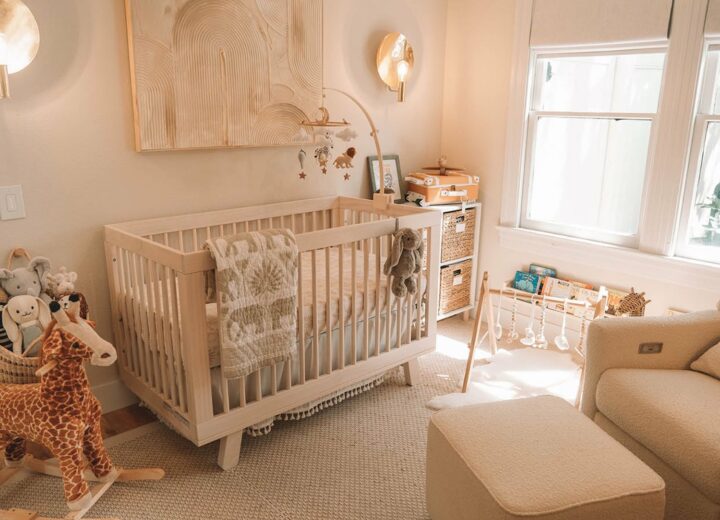 Interior of safari-themed nursery with mostly beige furniture and wild stuffed animals