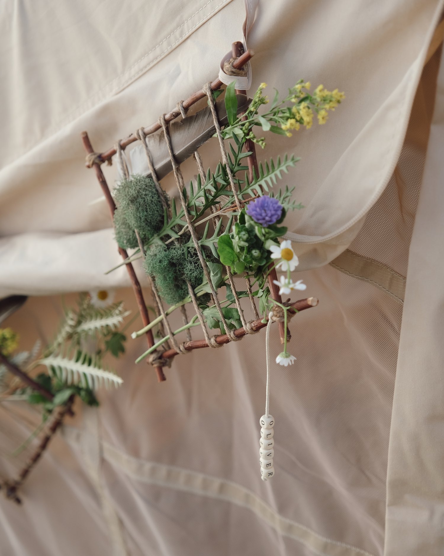 Close up of pretty garden flowers and plants woven into twig grid